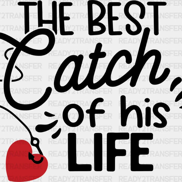 Black text saying The best catch of his life with a red heart fishing lure graphic